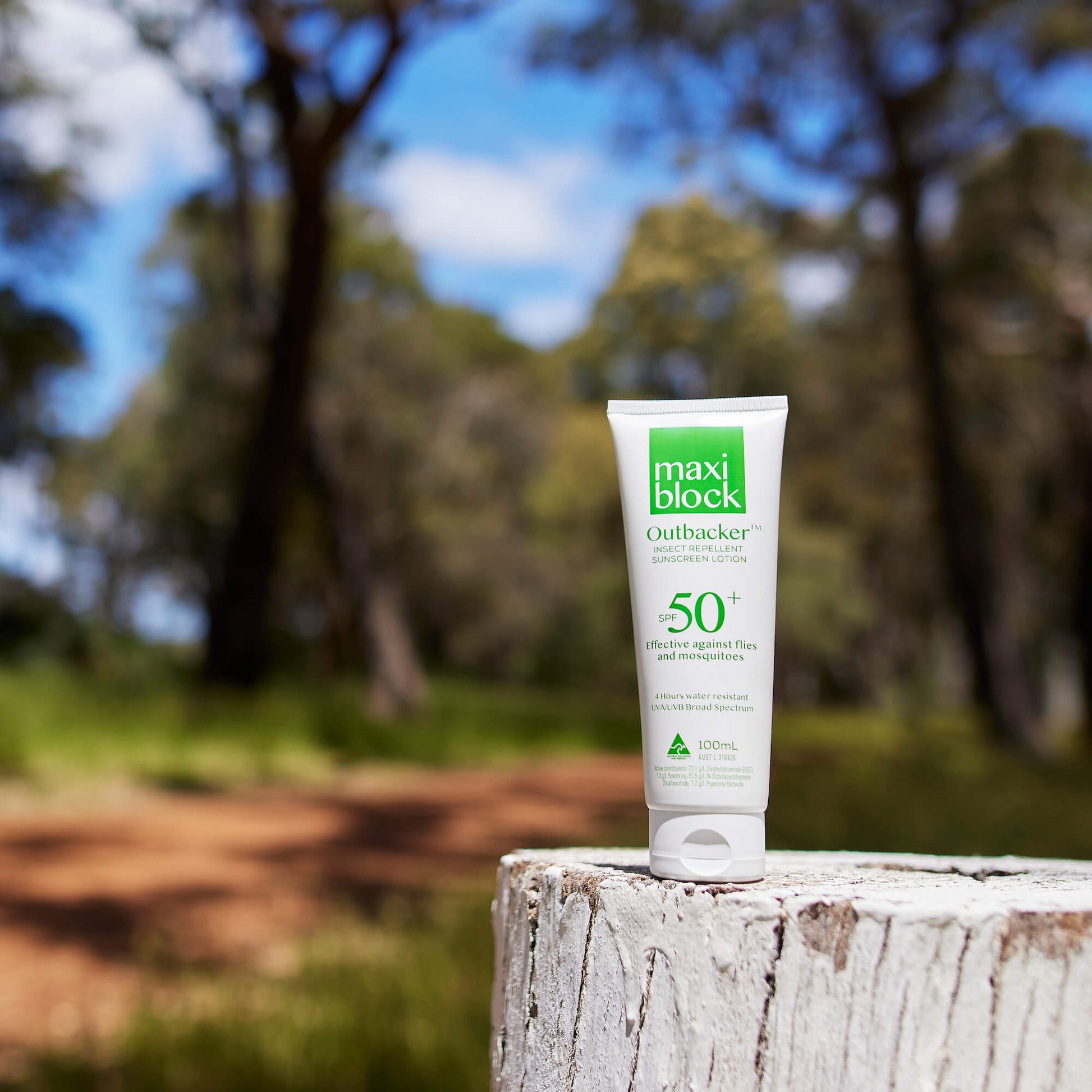 Maxiblock Outbacker Sunscreen with insect repellent tube SPF 50+ sitting on fence pole