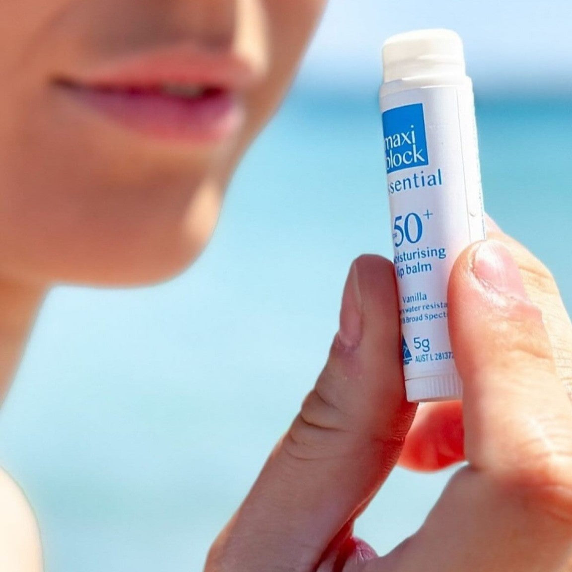 Person holding a Maxiblock Vanilla SPF Lip Balm 5g