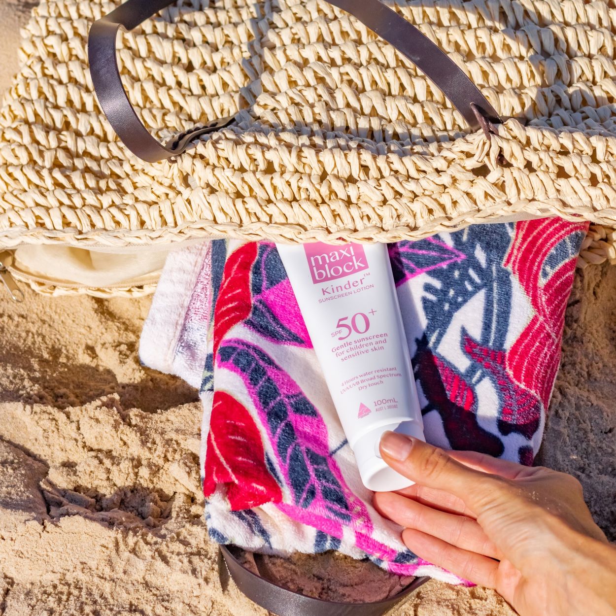 Sunscreen tube tucked inside a beach bag in the shade