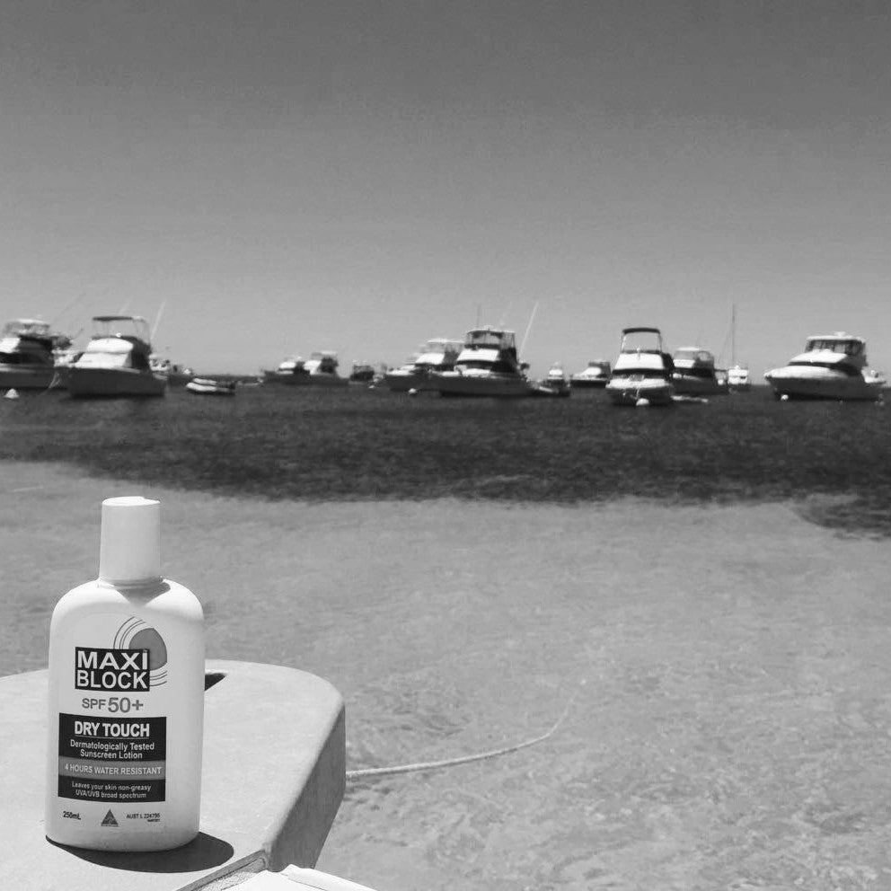 Maxiblock SPF 50+ Dry Touch sunscreen bottle in a black and white photo at Rottnest Island, Western Australia, 1980s