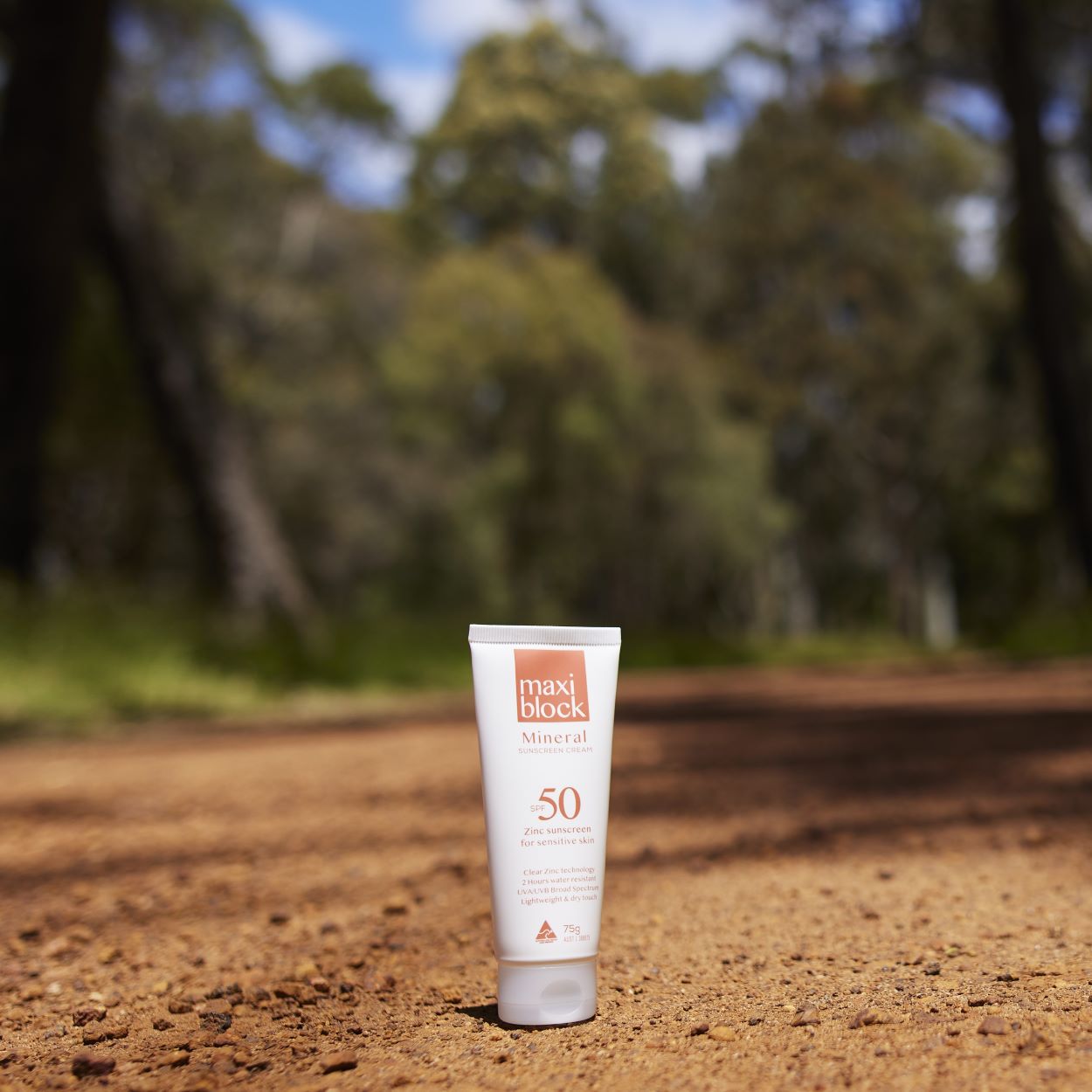 Maxiblock Mineral SPF 50 zinc oxide sunscreen 75g on a red dirt bush track