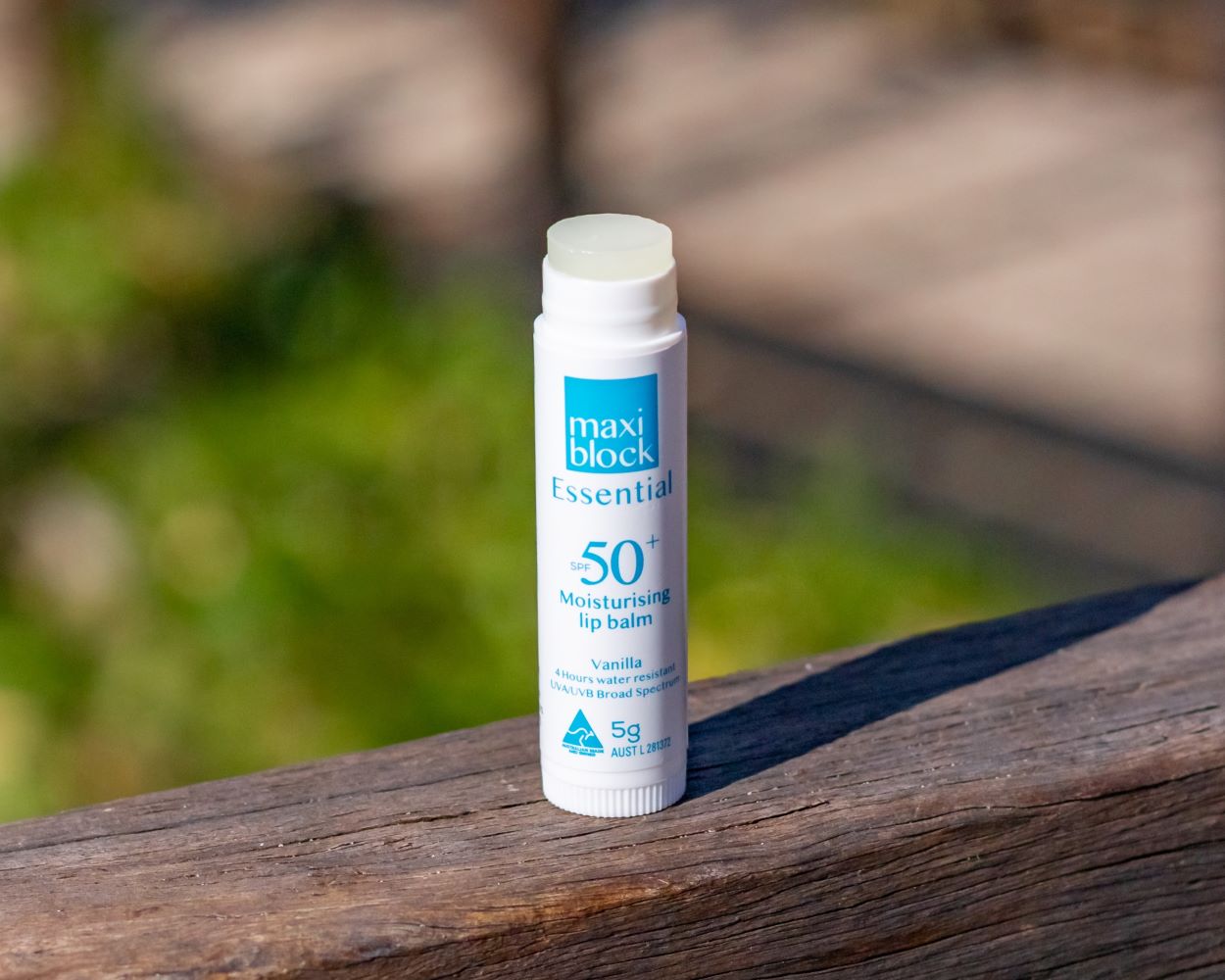SPF Lip Balm On A Wooden Handrail