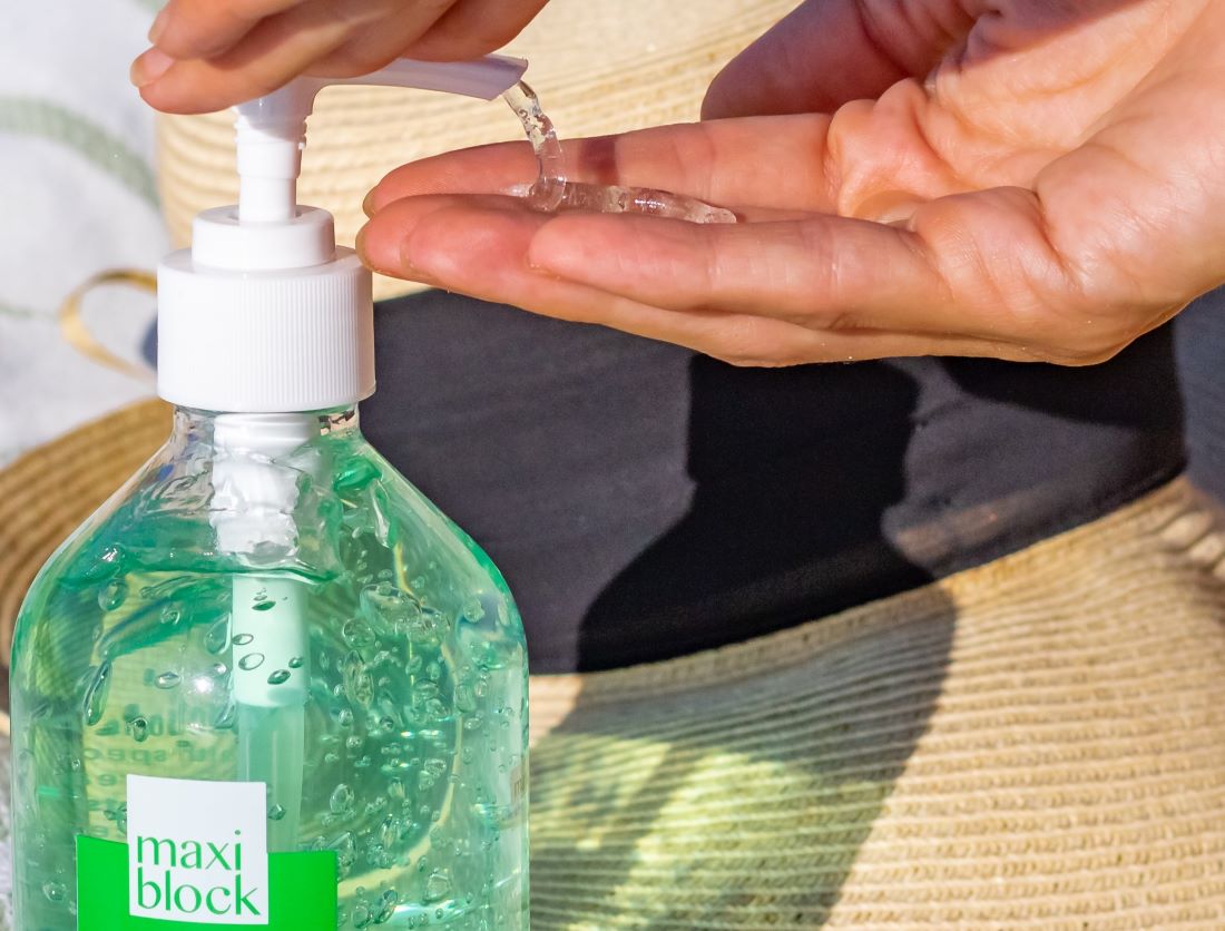 Maxiblock Aloe Vera Gel on fingertips showing clear gel texture.