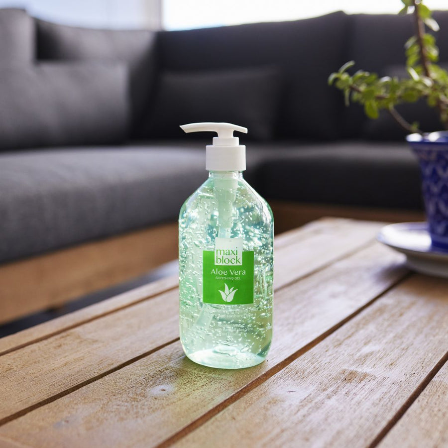 Maxiblock Aloe Vera Gel 500mL pump bottle on a wooden coffee table.