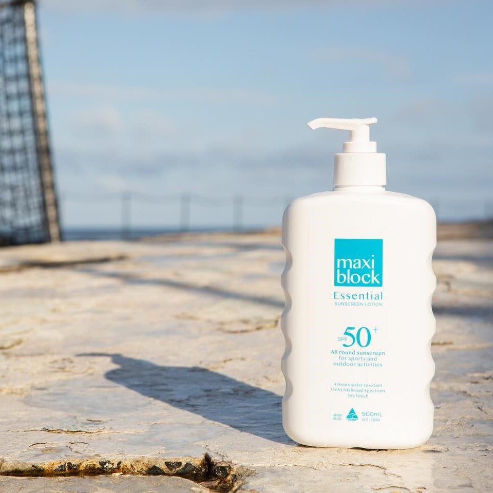 everyday sunscreen on concrete by the sea